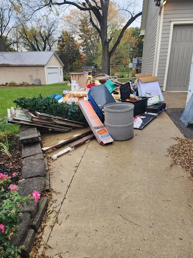 Dumpster being loaded with debris for Estate Cleanout Dumpster Rental in Oceanport